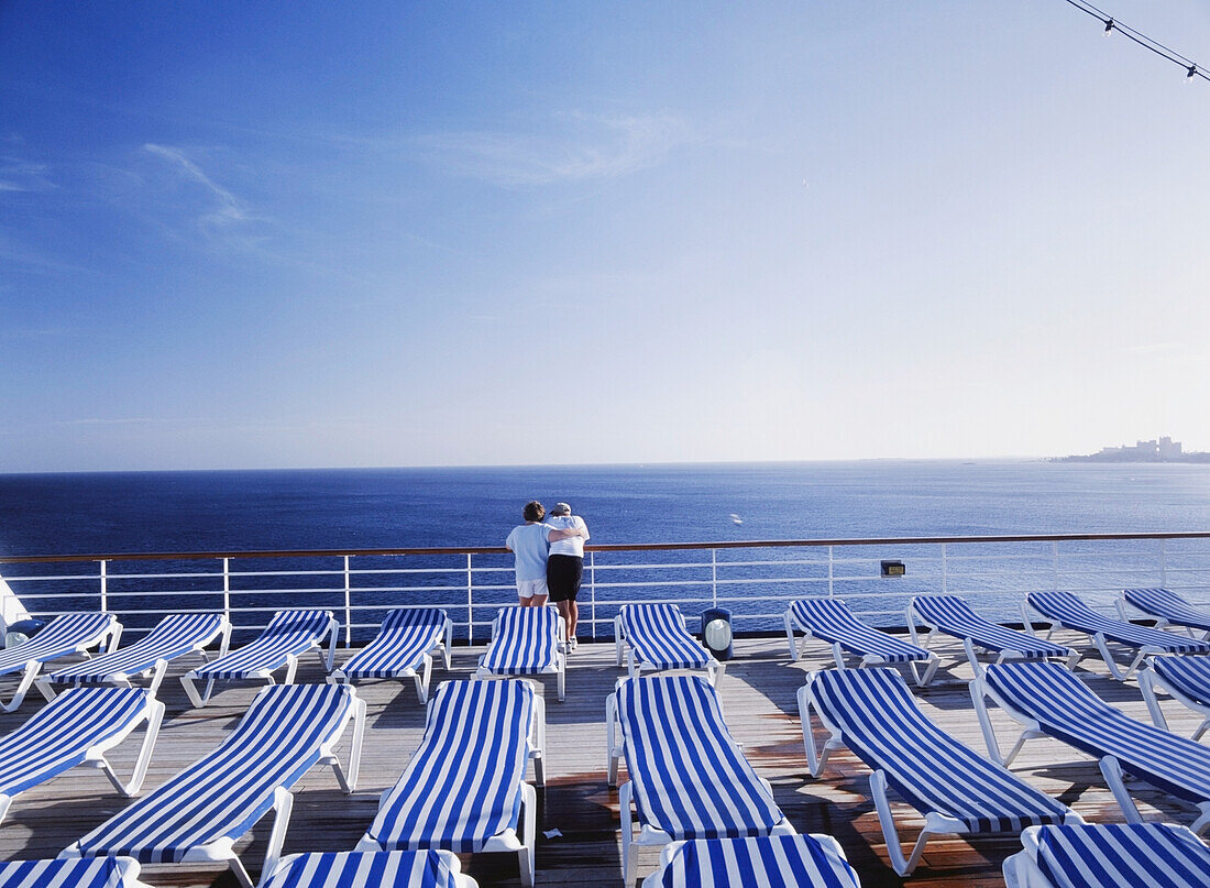 Mature Couple Hugging On The Desks Of Cruise Ship Off Bahamas