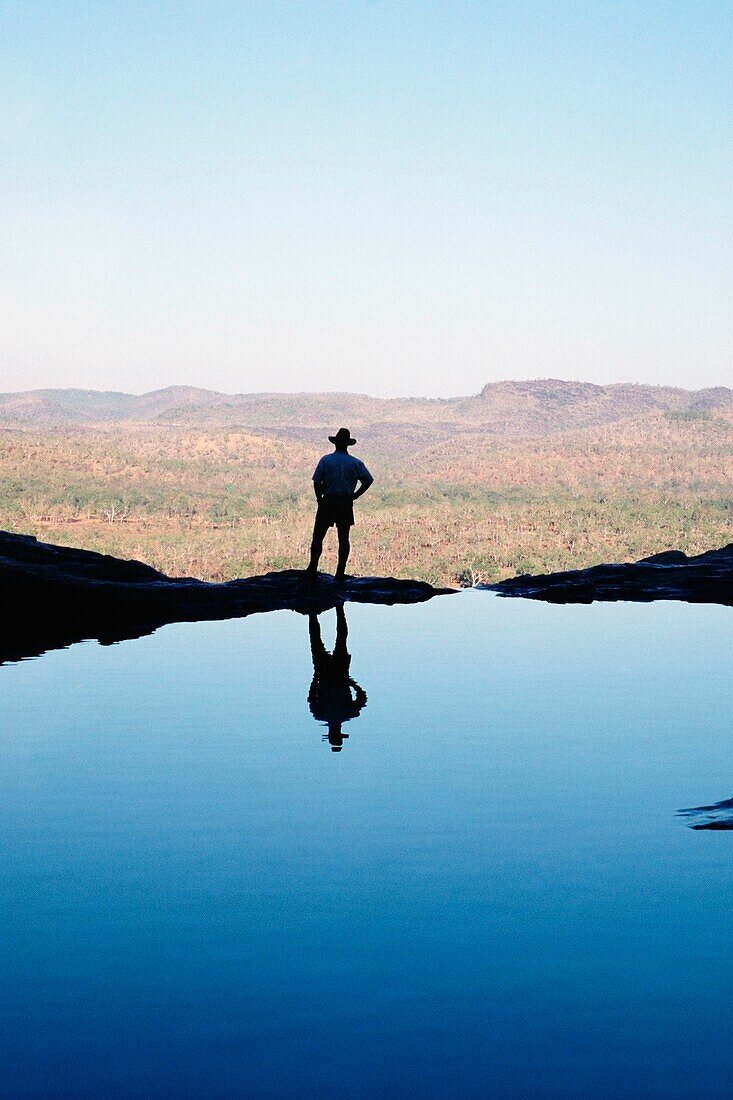 Man Standing Beside A Pool