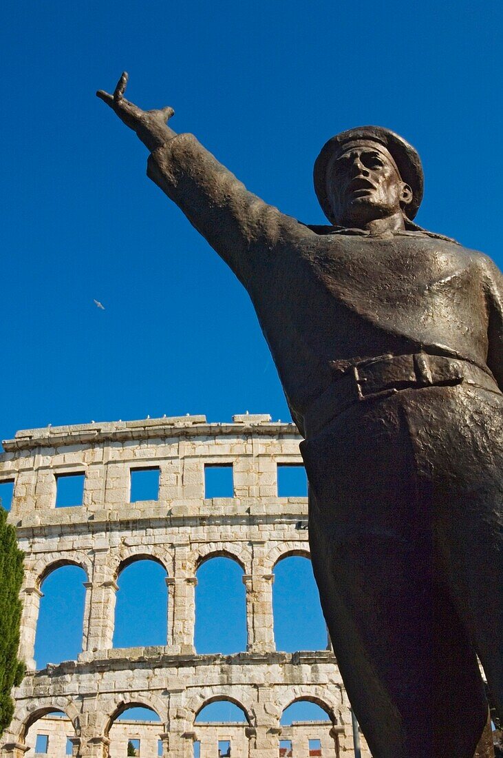 Bronze Statue In Front Of Roman Amphitheater.