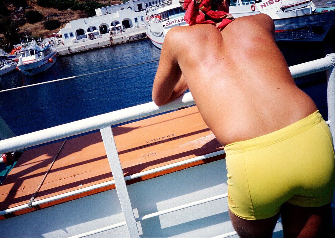 Man In Yellow Swim Trunks On A Ferry