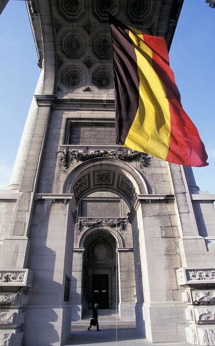 Mann geht am Arc De Triomphe vorbei