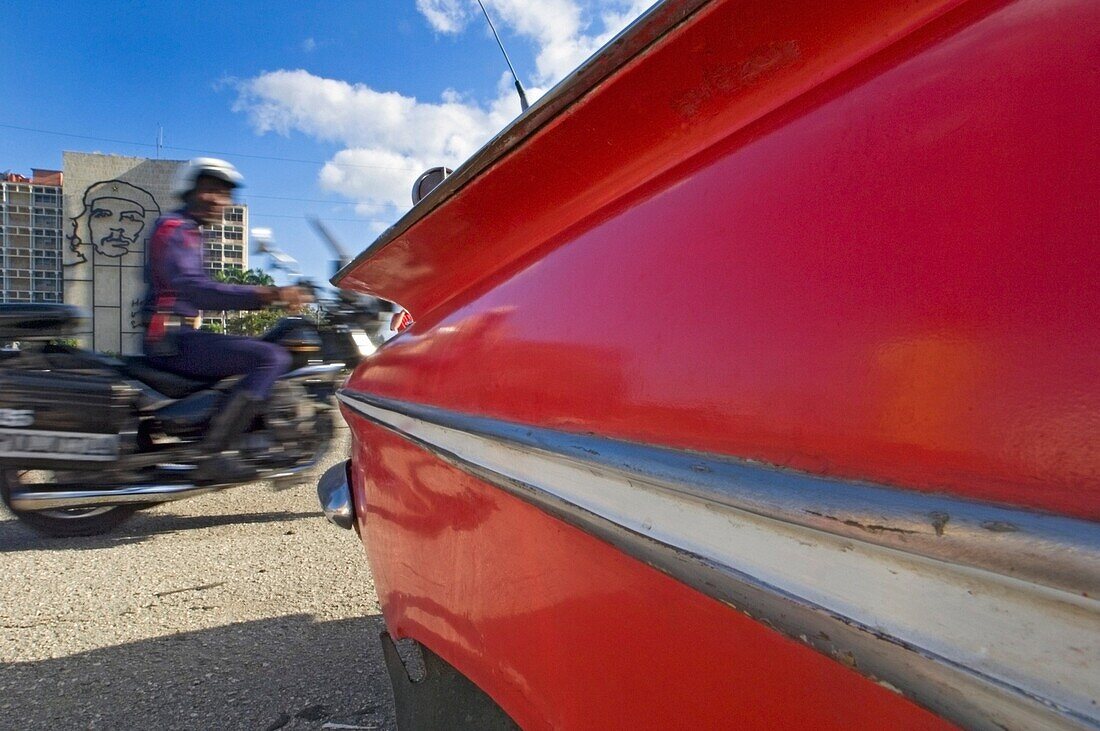 A Blurred Police Motorcyclist Passing The Che Guevara Sculpture In Plaza De La RevoluciÃ»n.