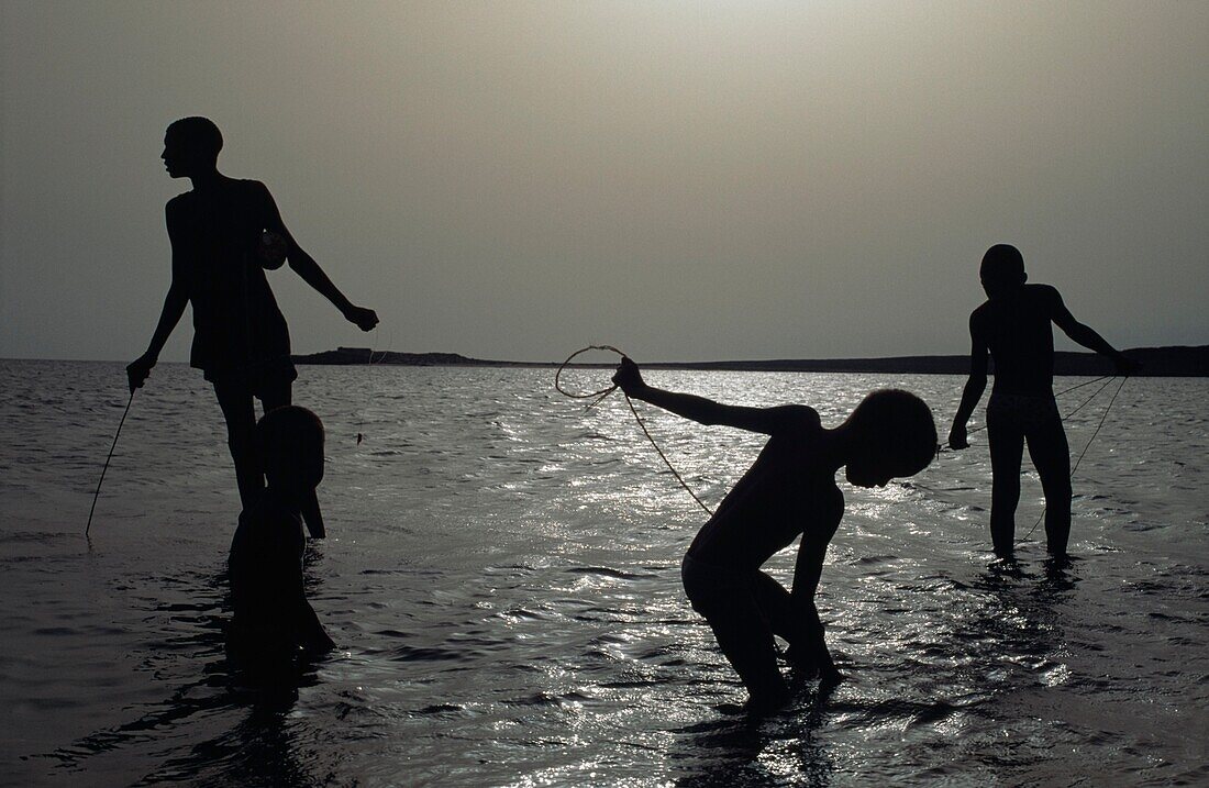 Silhouette Of Boys Fishing