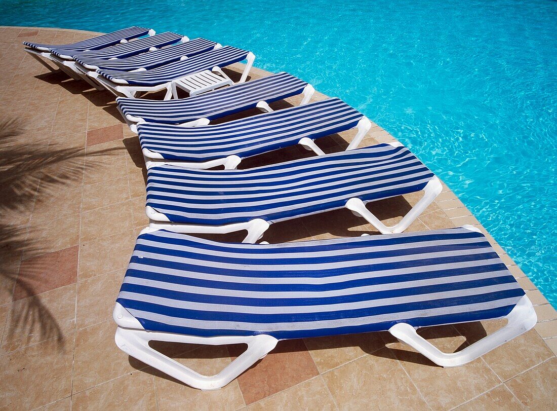 Sun Loungers Arranged Around The Pool