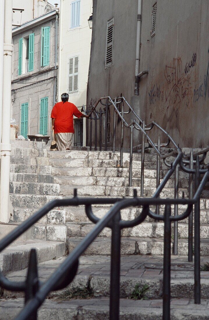 Woman Walking Up Steps In Le Panier District