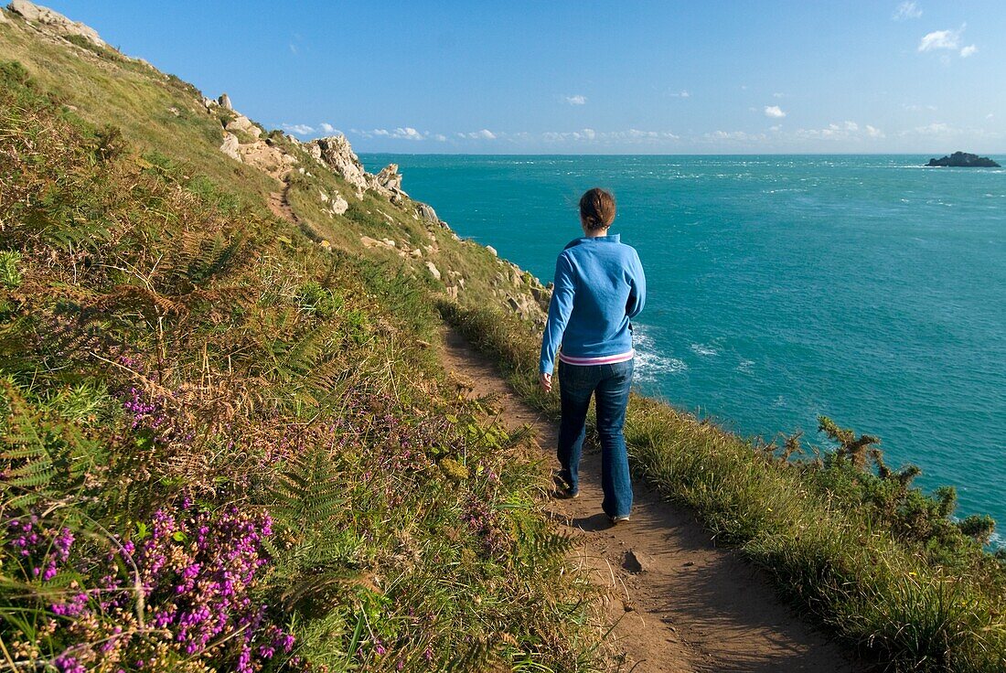 Woman Walking Along Coastal Path At The Pointe Du Grouin