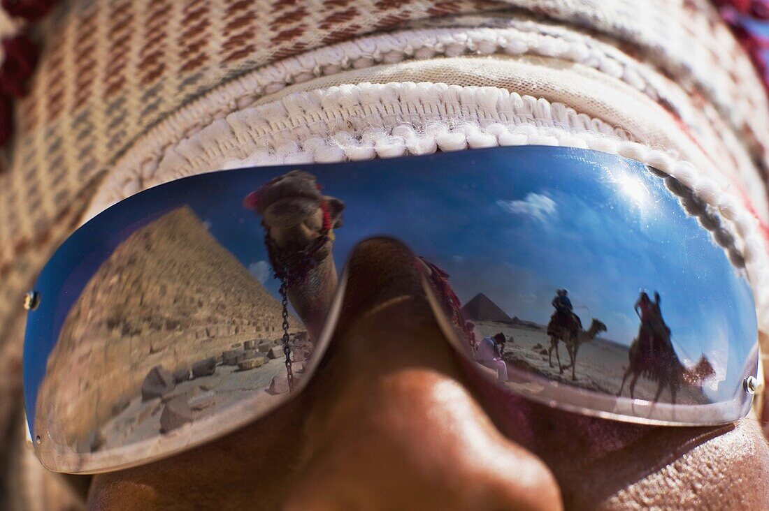 Camel And Pyramids Reflecting In Local Man's Sunglasses