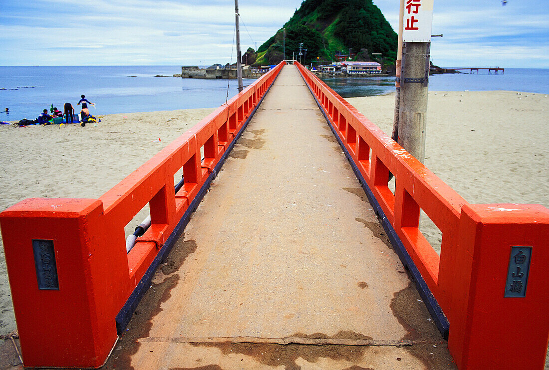 Red Footbridge On Beach Leading To Island