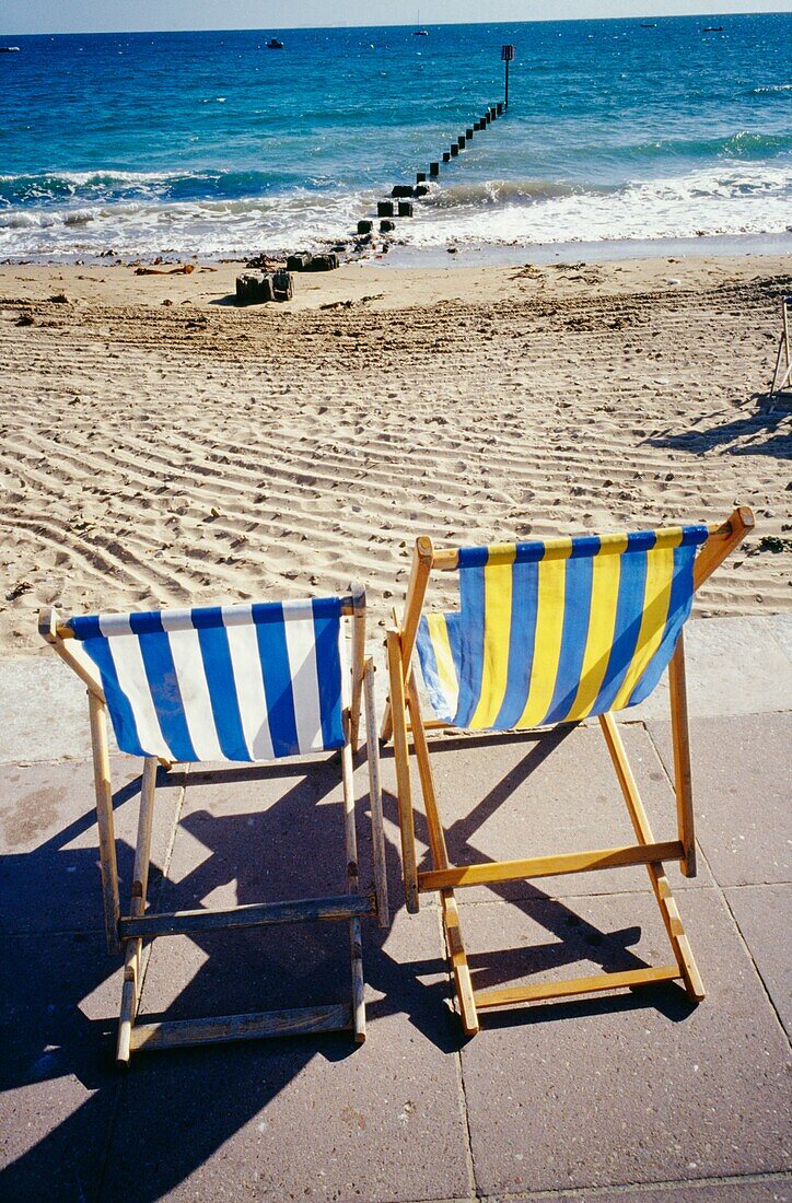 Empty Striped Beach Chairs On The Beach