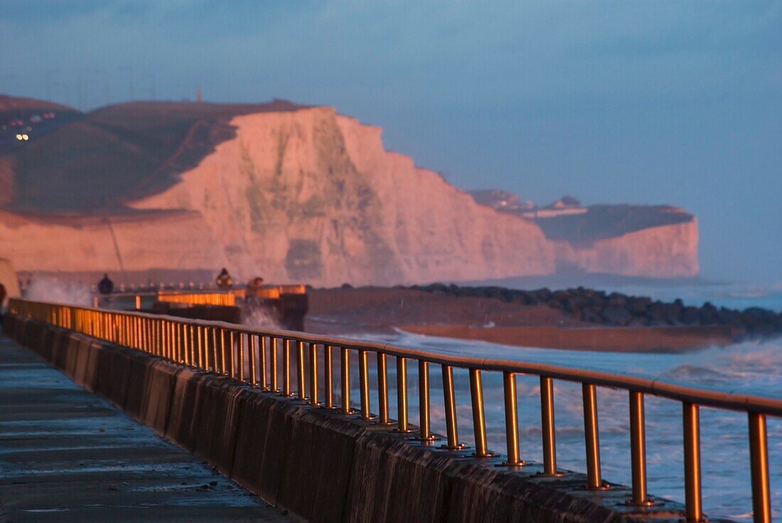 Walkway Beside Ocean And Cliffs At Sunset