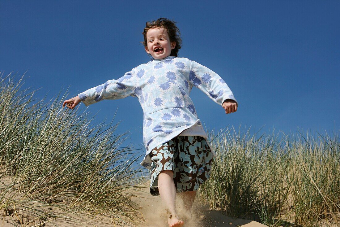 Girl Running Down Sand Dune