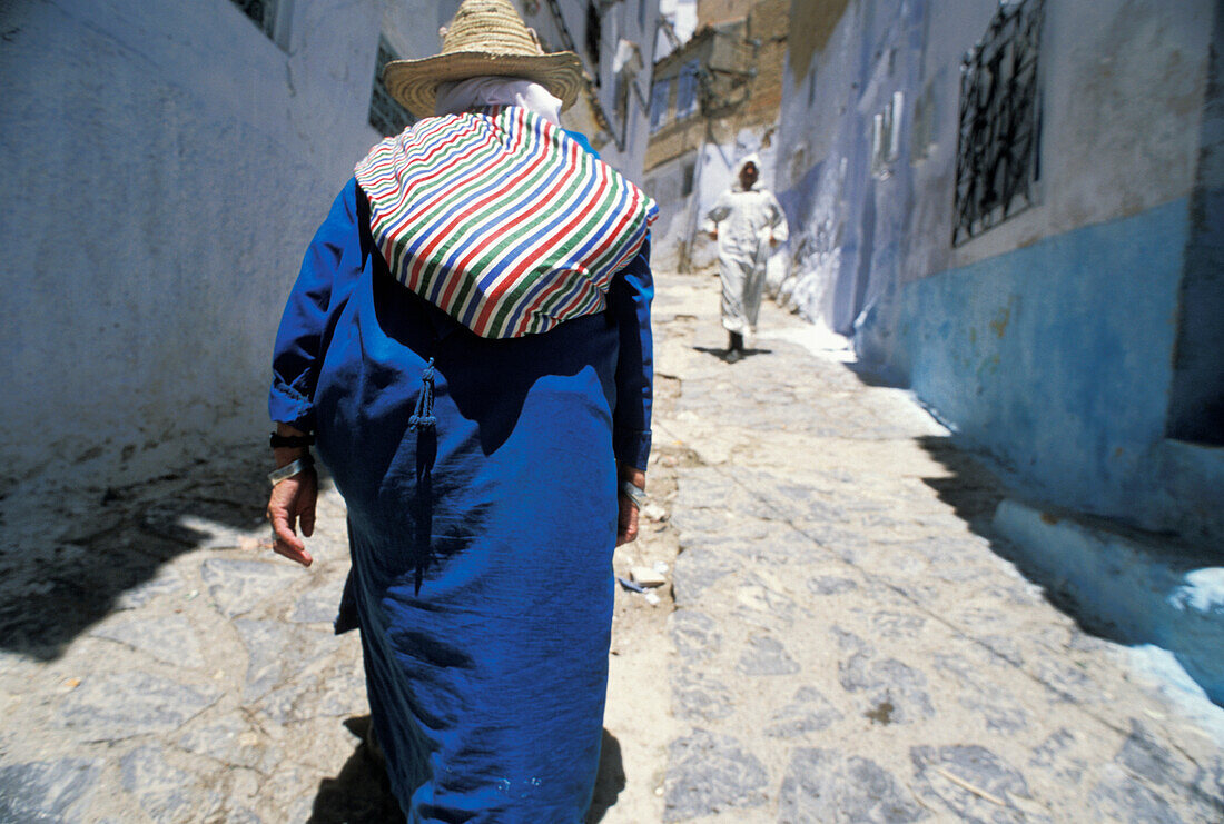 Local Man Carrying Bag On Cobbled Street