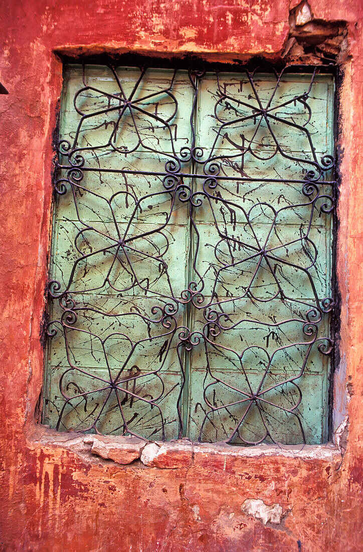 Detail Of Ornate Window With Grate And Shutters