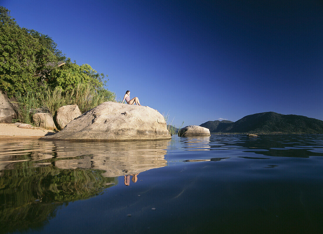 Woman Sitting On Rock On The Island Of Domwe