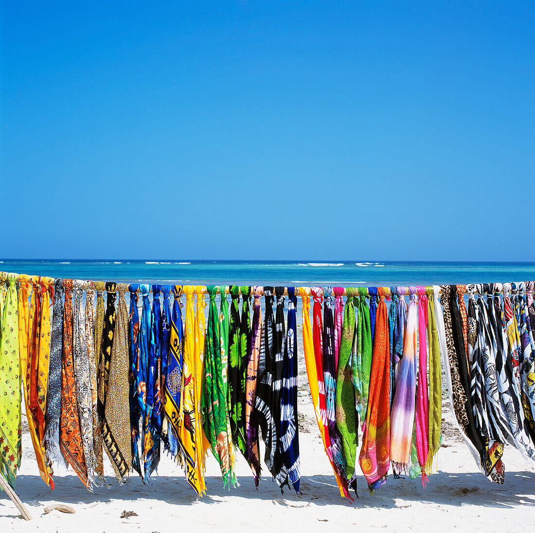 Colorful Sarongs Hanging Over White Sand Beach