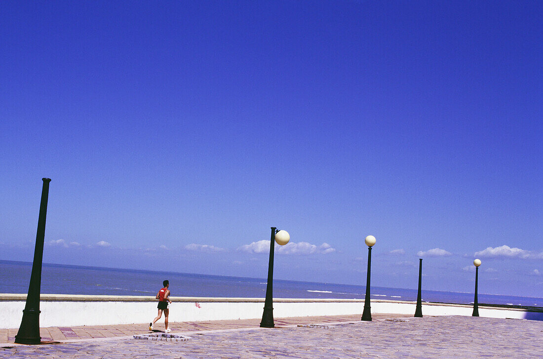 Man Jogging Along Playa De La Victoria