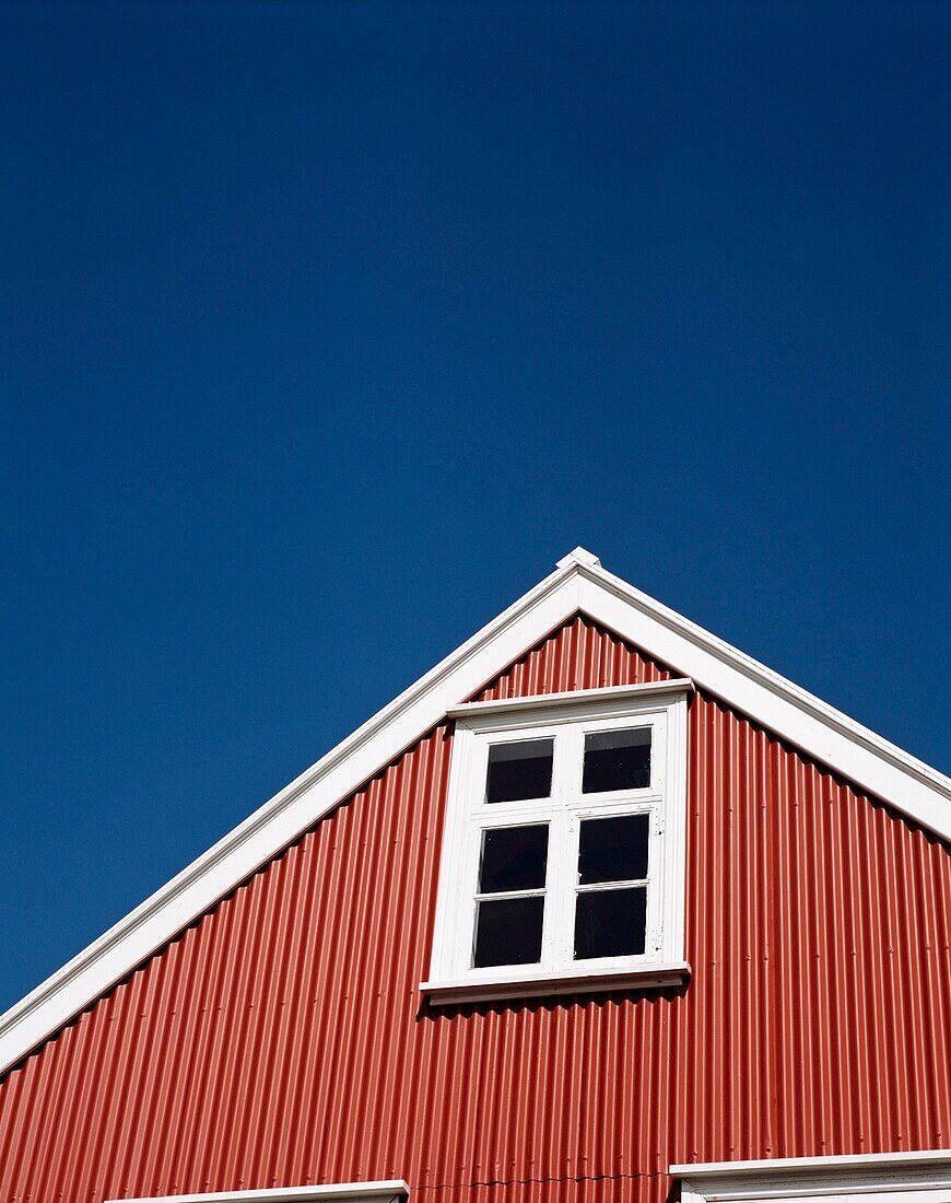 Red Wooden House With White Paned Window