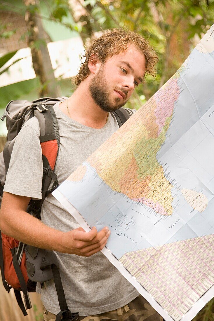 Backpacker Looking At Map Of India