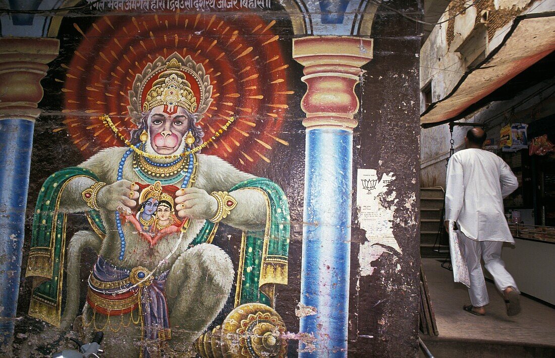 Man Walking Beside Wall Mural Of Hanuman Along The Streets Of Godaulia