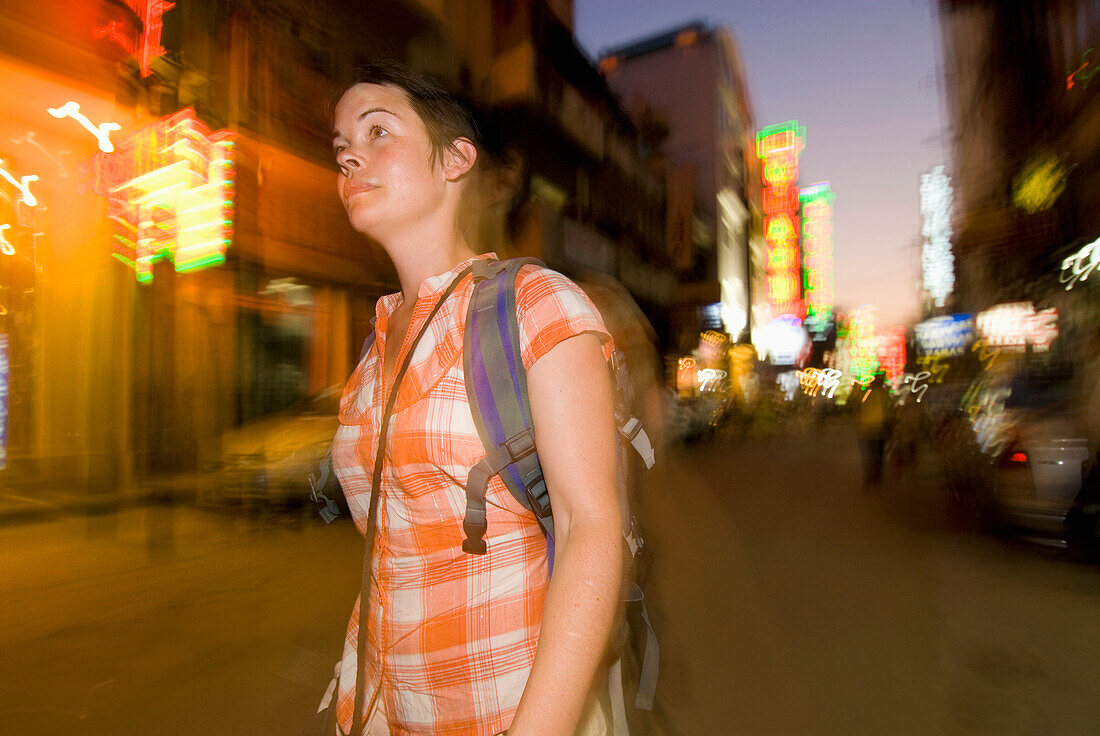 Tourist With Backpack Walking Down Small Street In Delhi At Dusk, Blurred Motion