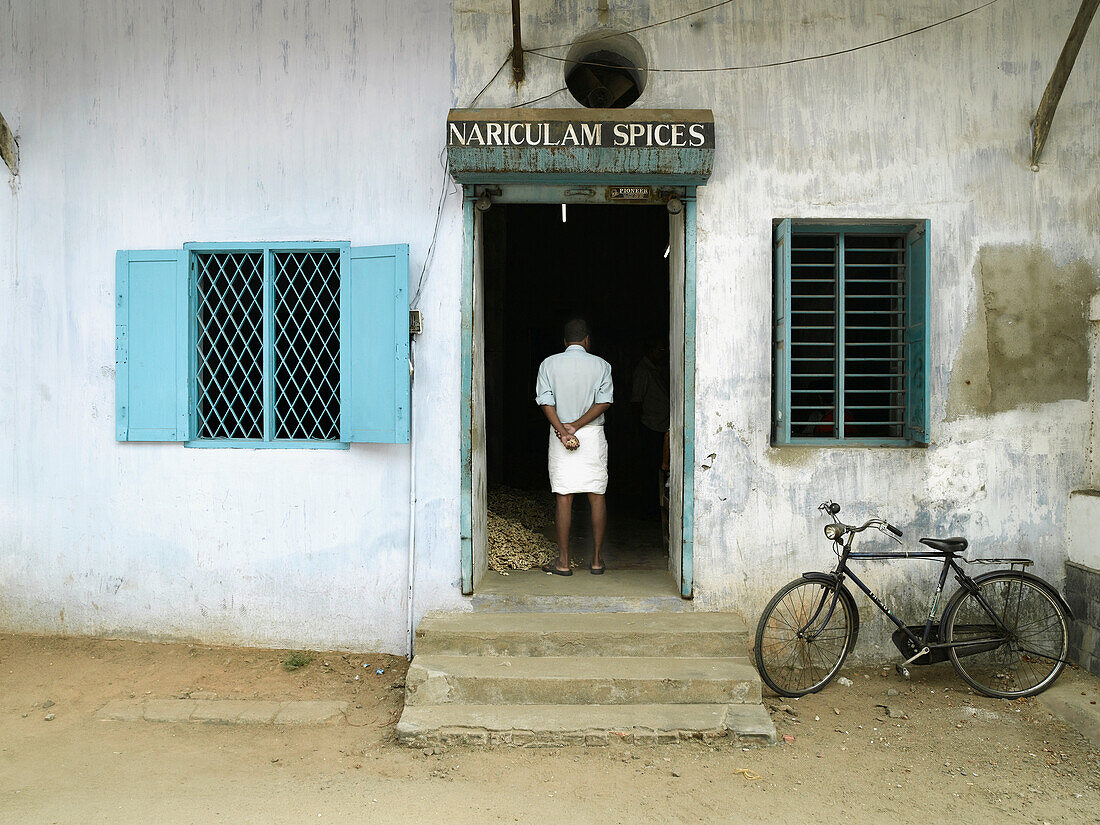 Man Standing In Doorway Of Shop