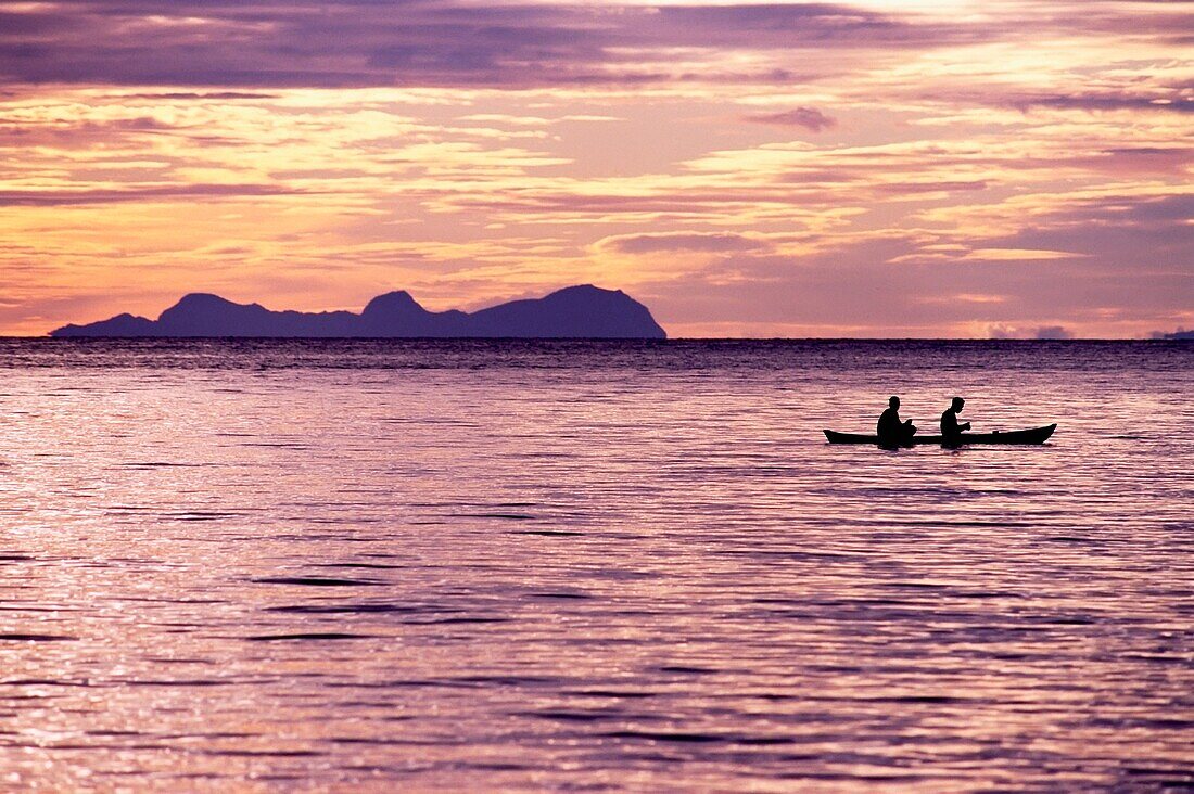 Two Fishermen Rowing In A Canoe