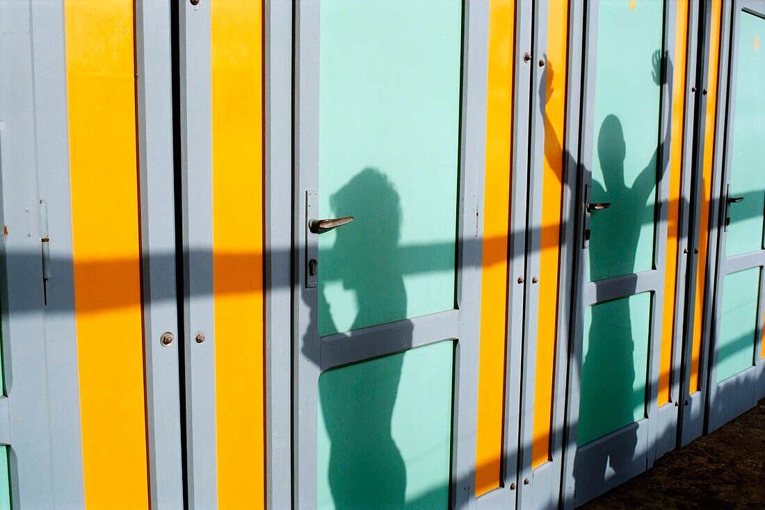 Tourists' Shadows In Beach Huts