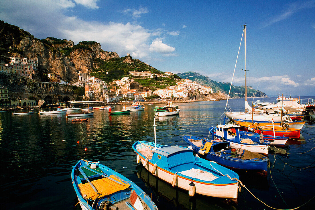 Sailboats And City On Rocky Shoreline