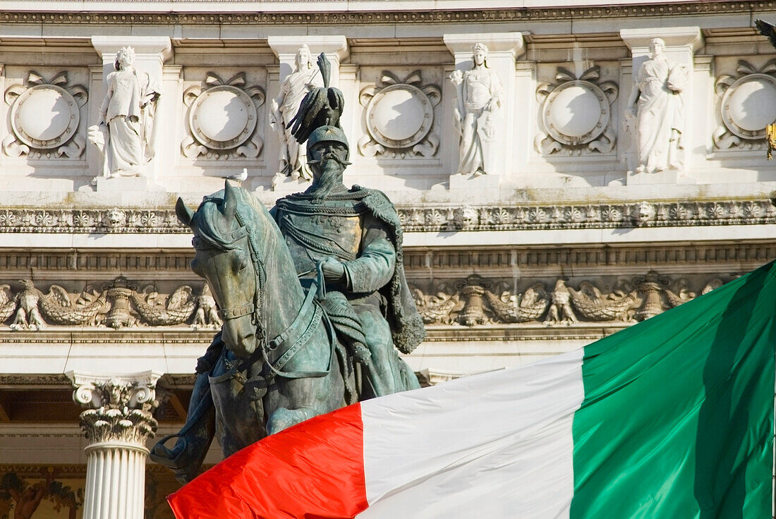 Statue Of King Emanuele Ii And Italian Flag In Front Of The Vittorio Emanuele Monument