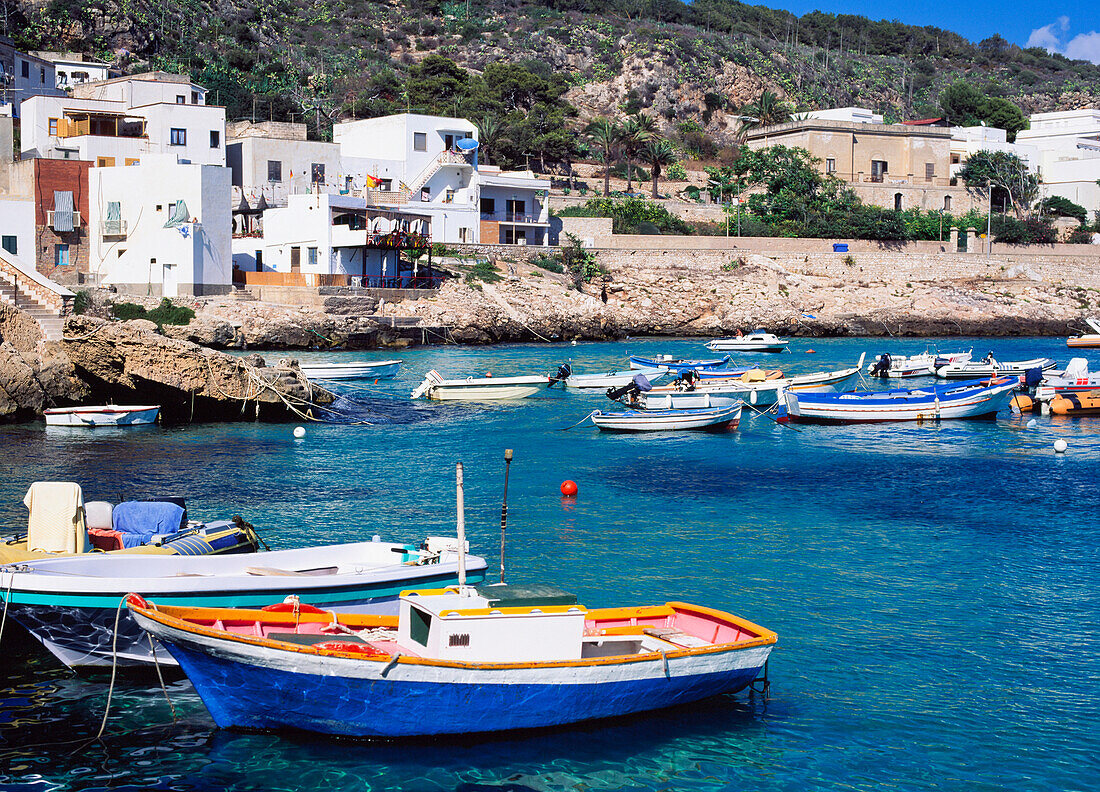View Over Water At Small Boats And Local Architecture On Levanzo Island.