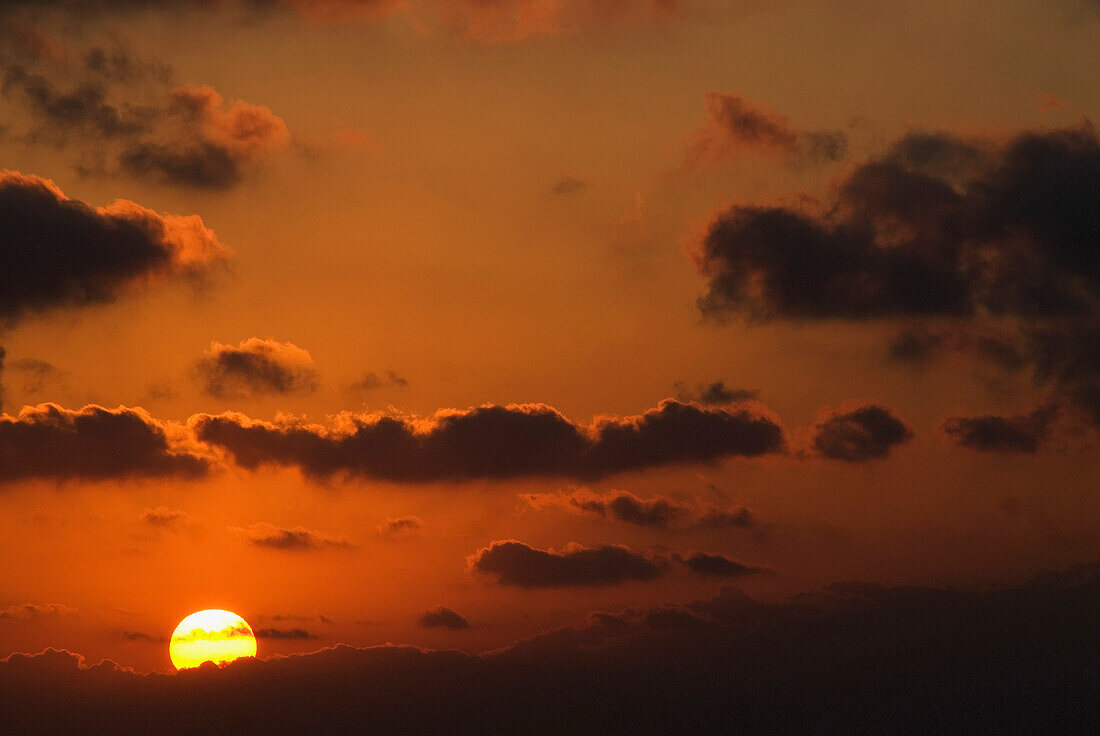 Sun And Clouds At Sunset In Orange Sky