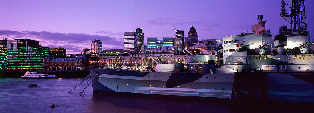 The Former British Cruiser Hms Belfast, Now Preserved As A Museum, Viewed From The Southbank, With The City Of London In The Background.