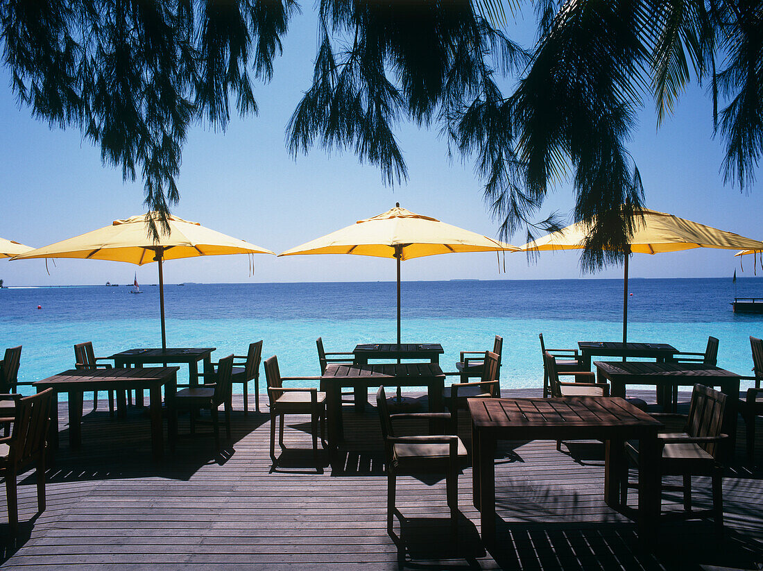 Deck Chairs, Tables And Umbrellas On Beach