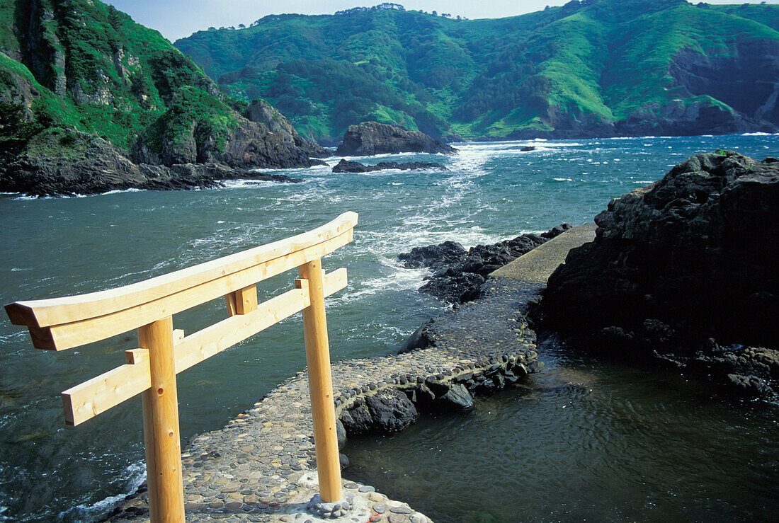 Wooden Tori Gate At End Of Path In Ocean