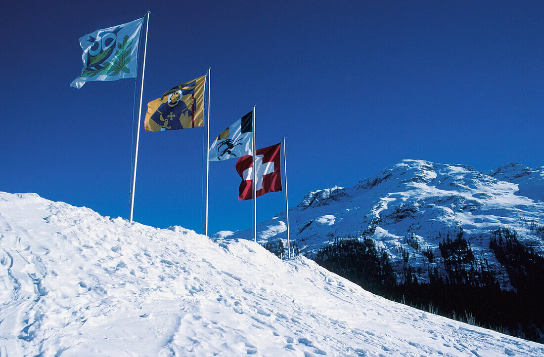 Flags On Top Of Snowy Mountains At St Moritz