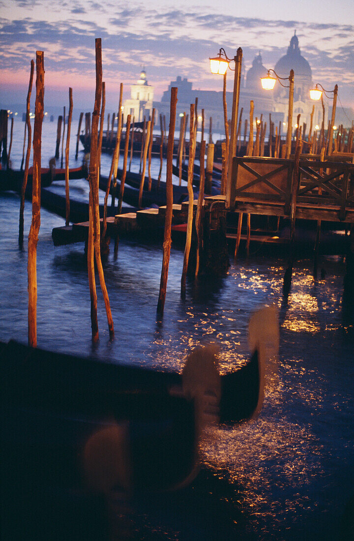 Gondeln in der Lagune mit Santa Maria Della Salute dahinter in der Abenddämmerung