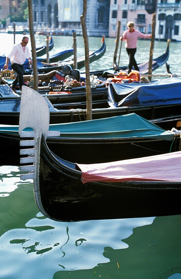 Gondolas On Grand Canal With Two Gondoliers In The Background