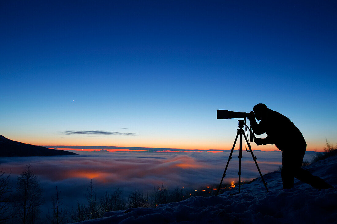 Silhouette Of Photographer At Sunset In Eagle River Valley, Southcentral, Alaska, Winter