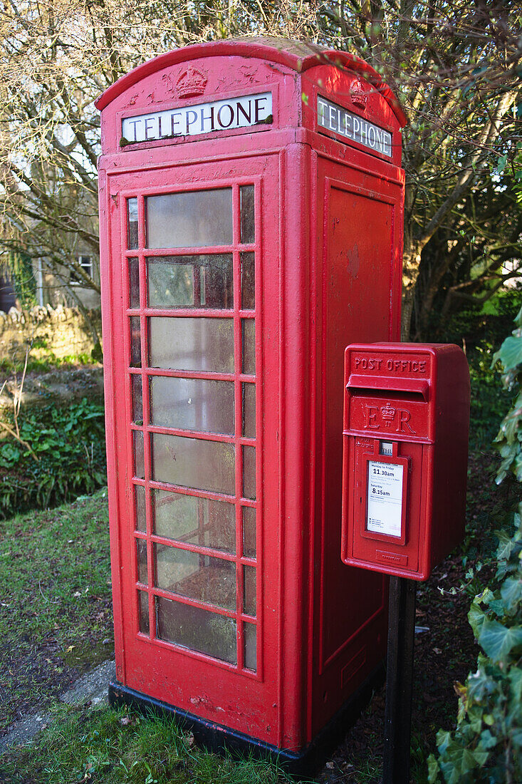 Traditional red telephone box next to red post box; Horsington Somerset England