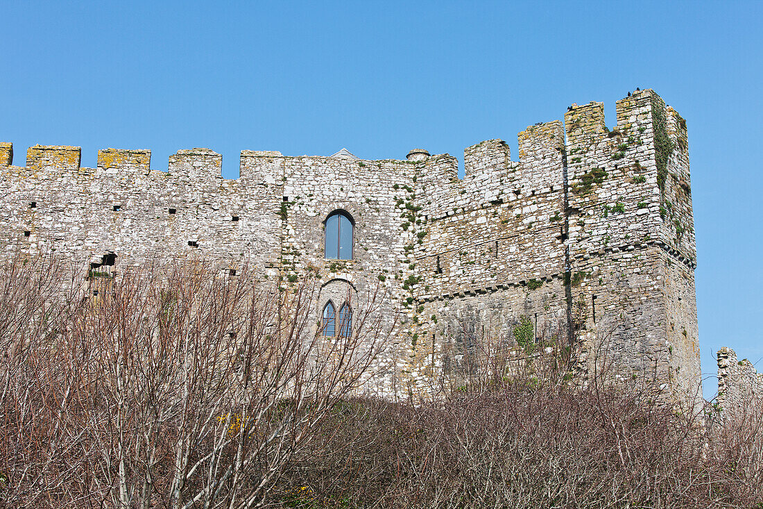 Ruins of a stone wall against a blue sky