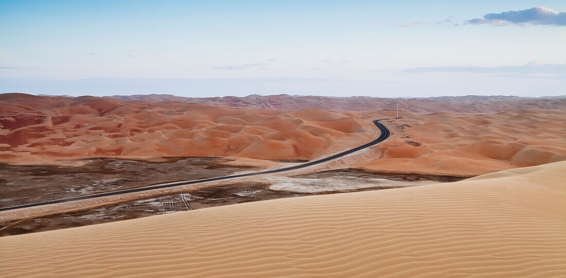 A Road Through The Desert Landscape; Liwa Oasis, Abu Dhabi, United Arab Emirates