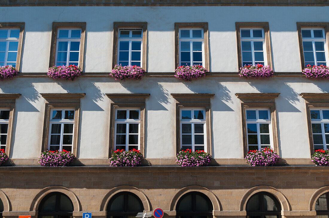 A Building With Windows Each Having A Blossoming Planter; Luxembourg City, Luxembourg