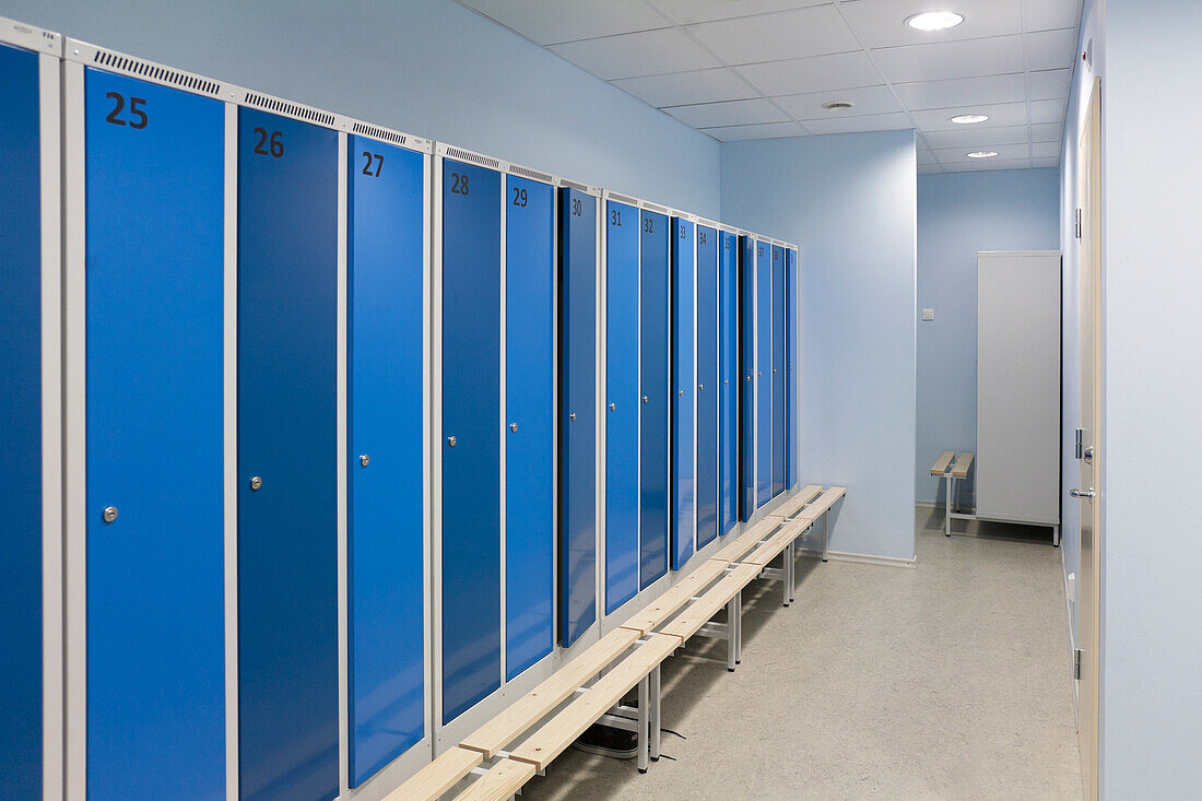 Sports and exercise facilities indoors in a gym, changing rooms, lockers with blue doors. 
