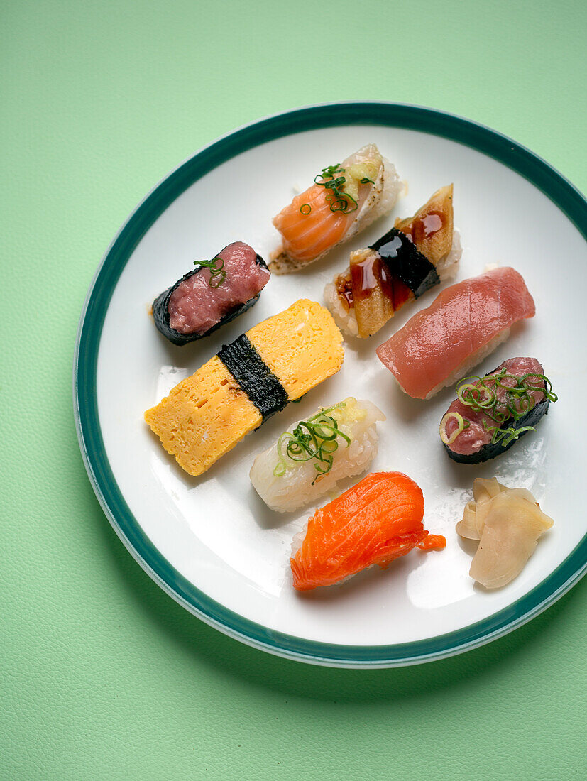 Sushi platter, a selection of raw fish and rice snacks with chopsticks. 