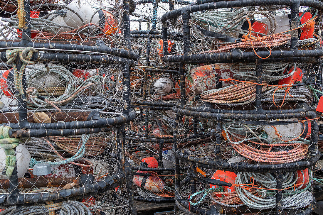 A quayside heap of commercial crab pots and nets, rope and floats. 