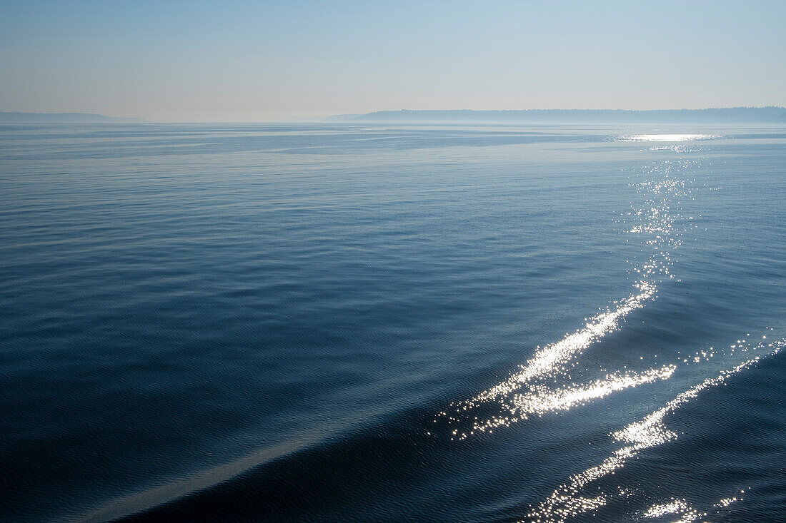 Das Kielwasser eines Fährschiffs, Wellen und Reflexionen auf dem Wasser. 