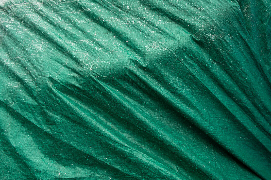 Close up of a tarpaulin cover with folds.