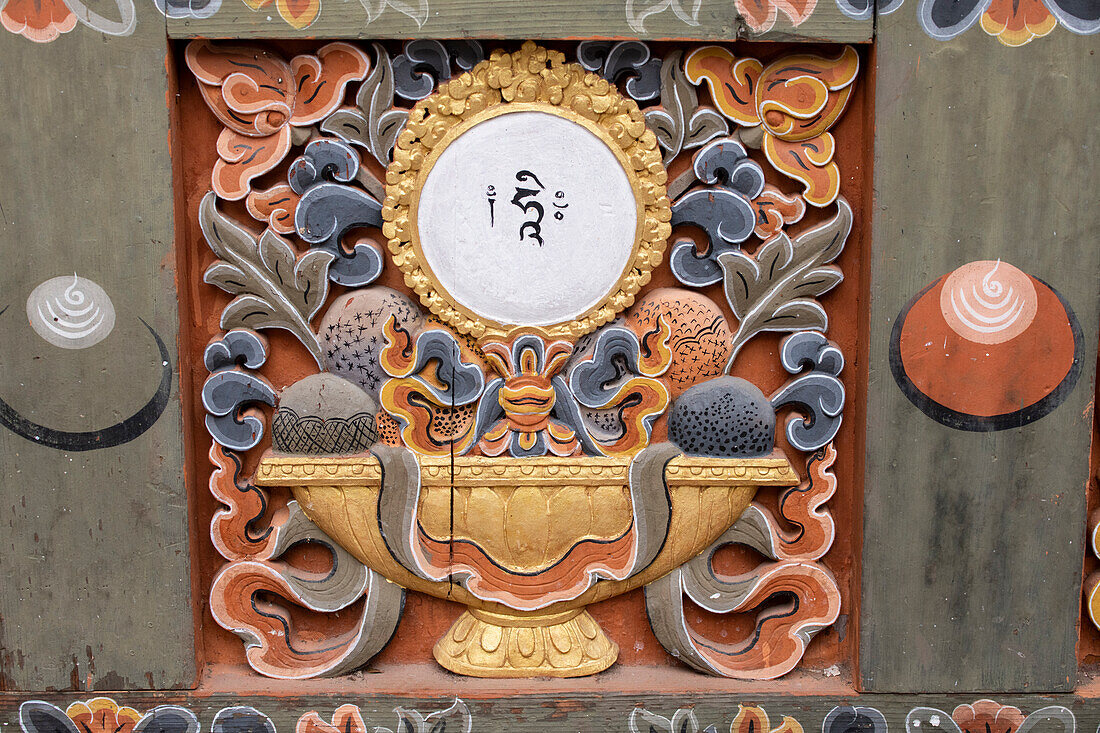 Bhutan, Punakha Dzong. Traditional hand painted and carved wooden architectural detail.