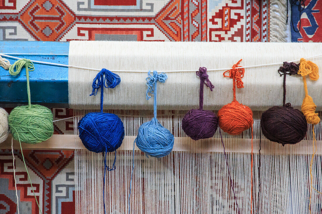 Turkey, Izmir Province, Selcuk, weaving loom, rug making, balls of wool or yarn.