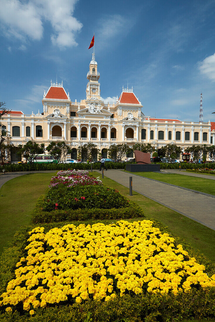 Flowers and historic People's Committee Building (former Hotel de Ville de Saigon), Ho Chi Minh City (Saigon), Vietnam